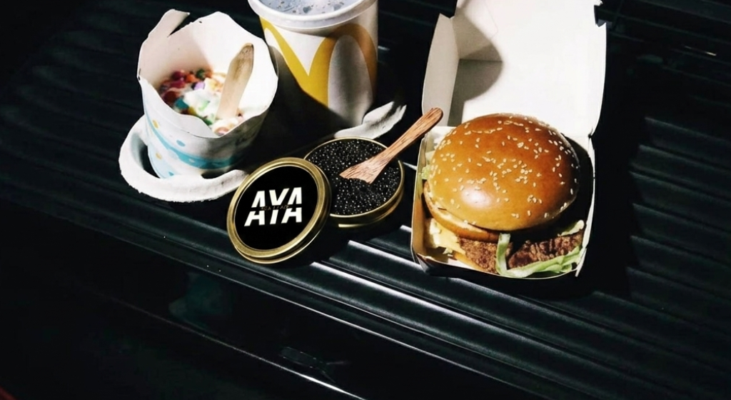 Hamburger on a car's open trunk with 'AVA' branding.
